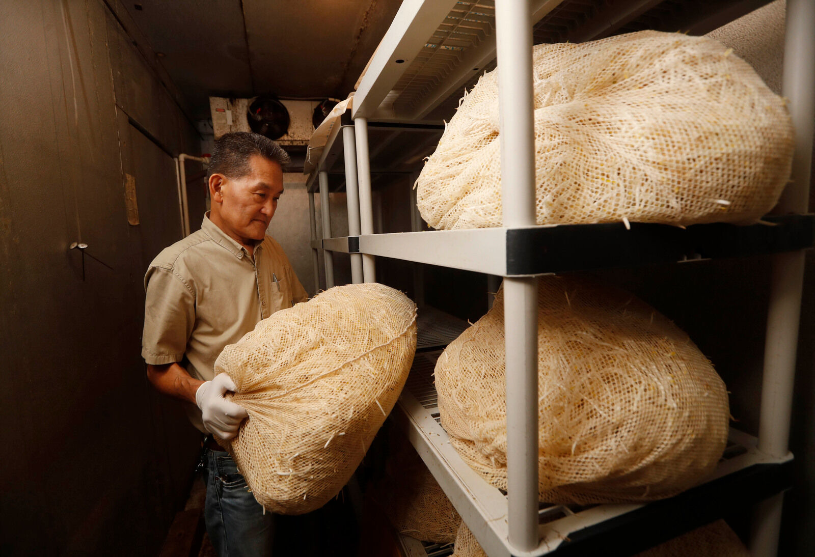 John Tsujimoto hefts last 45-pound bag of bean sprouts